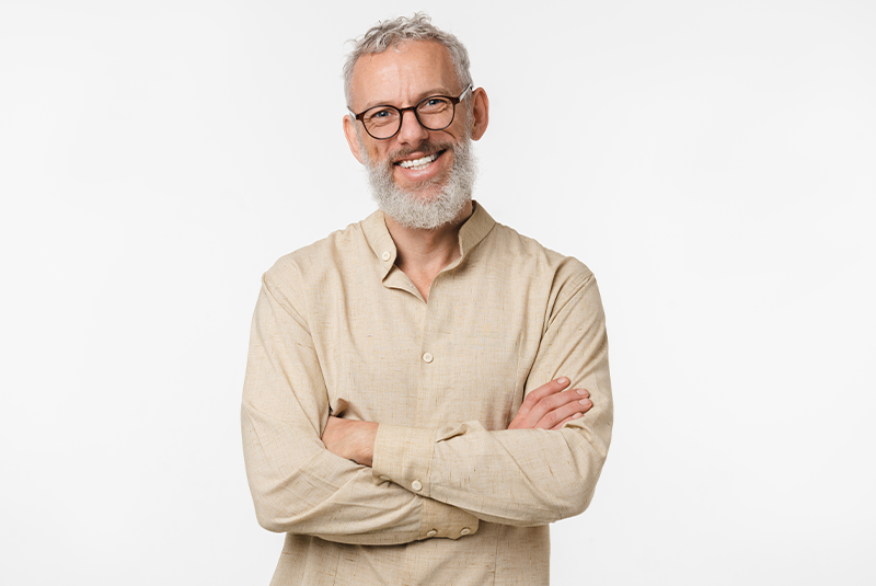 man smiling in a long sleeve kaki shirt